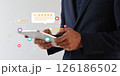Businessman using hand on tablet with floating digital review icons. 126186502