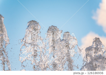 Splashes and jets of water against light background. 126186936