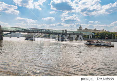 View of the Moscow river embankment, Pushkinsky bridge and cruise ships at sunset. View of the Moscow river embankment, Pushkinsky bridge and cruise ships at sunset. 126186959