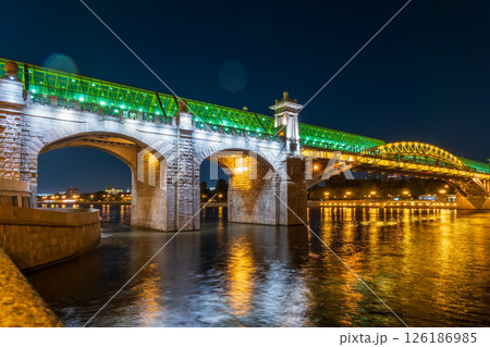 Pushkinskiy bridge with night illumination. Bridge to Gorky Park. Pushkinskiy bridge with night illumination. Bridge to Gorky Park. 126186985