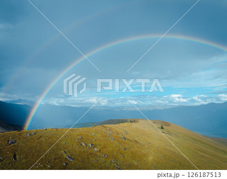 Beautiful  double rainbow after the rain on high altitude mountain top 126187513
