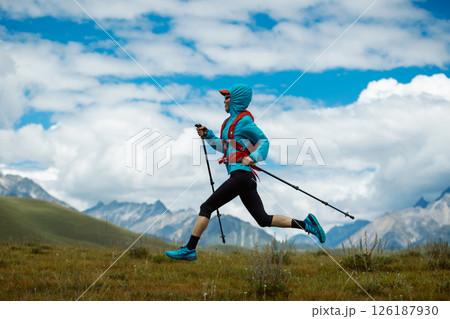 Fitness woman trail runner running in grassland 126187930