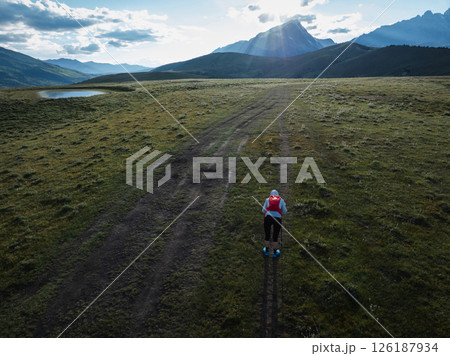 Aerial view of woman trail runner in high altitude mountains 126187934