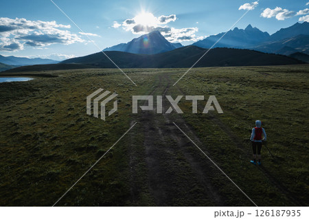 Aerial view of woman trail runner in high altitude mountains 126187935