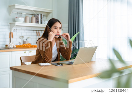 Asian young woman seriously working on computer laptop in house 126188464