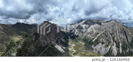 Aerial view of beautiful high altitude forest canyon and snow capped mountain landscape 126188908
