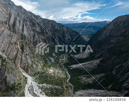 Aerial view of beautiful high altitude forest canyon and snow capped mountain landscape 126188938