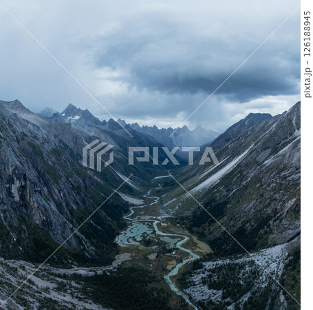 Aerial view of beautiful high altitude forest canyon and snow capped mountain landscape Aerial view of beautiful high altitude forest canyon and snow capped mountain landscape 126188945
