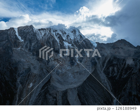 Aerial view of beautiful high altitude forest canyon and snow capped mountain landscape 126188949