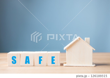 wooden block and safe a piggy bank house, donation, charity, fundraising, investment, saving, family finance plan concept, The idea of protecting your home with home insurance. 126189315