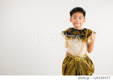 Portrait Thailand kid boy smiling traditional Thai dress costume makes thumbs up OK sign, symbolizing agreement, studio isolated white background, primary child radiates positivity and satisfaction Portrait Thailand kid boy smiling traditional Thai dress costume makes thumbs up OK sign, symbolizing agreement, studio isolated white background, primary child radiates positivity and satisfaction 126189377