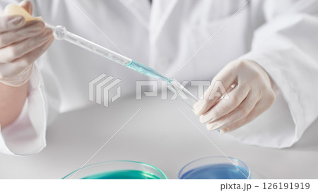 Hands Performing Scientific Experiments in a Modern Laboratory Setting. Hands Performing Scientific Experiments in a Modern Laboratory Setting. 126191919