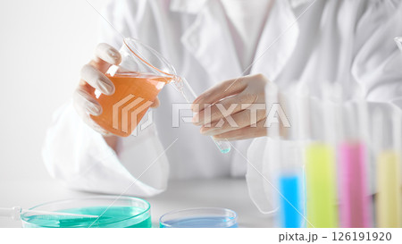 Hands Performing Scientific Experiments in a Modern Laboratory Setting. Hands Performing Scientific Experiments in a Modern Laboratory Setting. 126191920