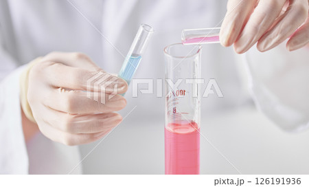 Hands Performing Scientific Experiments in a Modern Laboratory Setting. 126191936