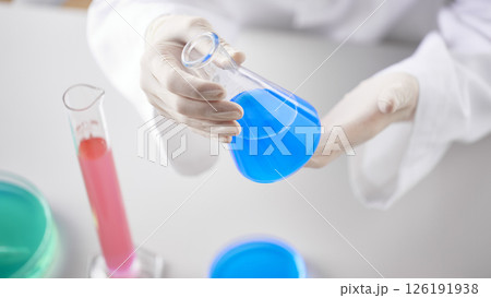 Hands Performing Scientific Experiments in a Modern Laboratory Setting. Hands Performing Scientific Experiments in a Modern Laboratory Setting. 126191938
