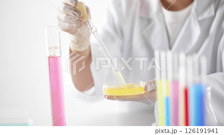 Hands Performing Scientific Experiments in a Modern Laboratory Setting. 126191941