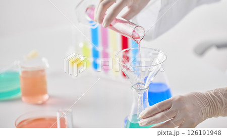 Hands Performing Scientific Experiments in a Modern Laboratory Setting. Hands Performing Scientific Experiments in a Modern Laboratory Setting. 126191948