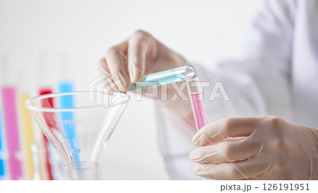 Hands Performing Scientific Experiments in a Modern Laboratory Setting. Hands Performing Scientific Experiments in a Modern Laboratory Setting. 126191951