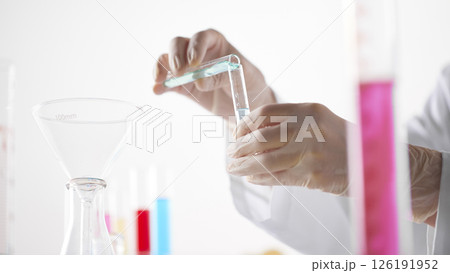 Hands Performing Scientific Experiments in a Modern Laboratory Setting. Hands Performing Scientific Experiments in a Modern Laboratory Setting. 126191952