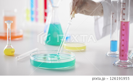 Hands Performing Scientific Experiments in a Modern Laboratory Setting. 126191955