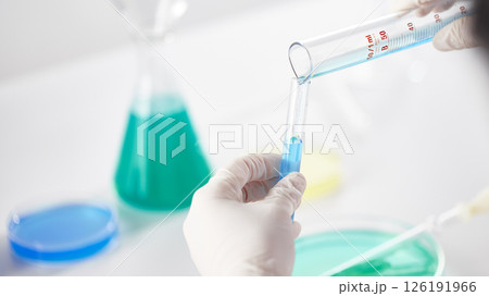Hands Performing Scientific Experiments in a Modern Laboratory Setting. Hands Performing Scientific Experiments in a Modern Laboratory Setting. 126191966