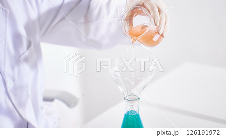 Hands Performing Scientific Experiments in a Modern Laboratory Setting. 126191972