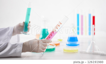 Hands Performing Scientific Experiments in a Modern Laboratory Setting. 126191980