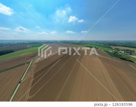 Stunning Aerial View of a Beautiful Agricultural Landscape Under Clear Blue Sky and Sunshine Stunning Aerial View of a Beautiful Agricultural Landscape Under Clear Blue Sky and Sunshine 126193596