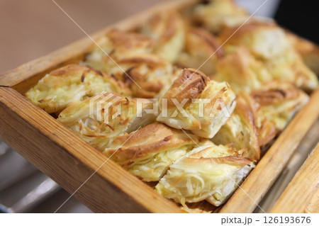 fresh bagels with butter and cheese on plate and cup of coffee on ceramic background 126193676