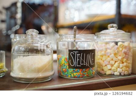 Colorful Candy Jars with Stelline and Marshmallows Display Colorful Candy Jars with Stelline and Marshmallows Display 126194682
