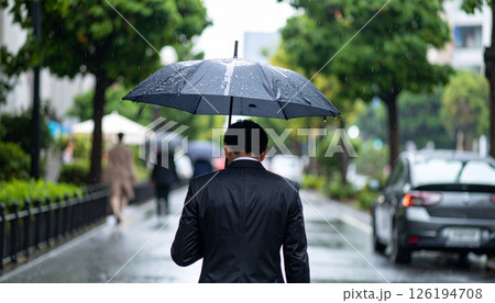 傘をさすビジネスマンの後ろ姿（AI生成画像） 126194708