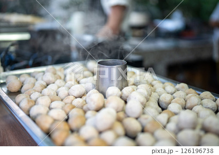 Pork meatballs steam and grill on portable stove at street food vendor cooking stall. Thai market 126196738