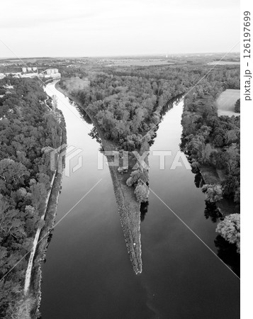 Aerial view showcasing the striking confluence of the Vltava and Labe rivers near Melnik in Czechia. This unique landscape reveals the meeting point of two significant waterways. Aerial view showcasing the striking confluence of the Vltava and Labe rivers near Melnik in Czechia. This unique landscape reveals the meeting point of two significant waterways. 126197699
