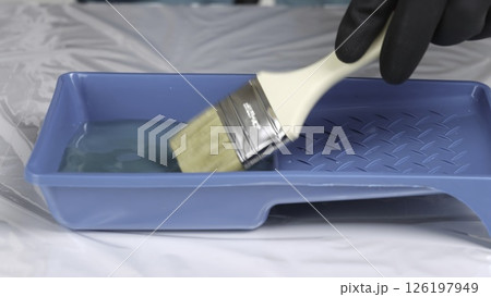 Preparing Paint Using a Brush in a Tray for Various Artistic Applications and Projects. Creative Preparing Paint Using a Brush in a Tray for Various Artistic Applications and Projects. Creative 126197949