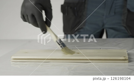 A craftsperson transforms wood with a beautiful stain, showcasing techniques. Creative A craftsperson transforms wood with a beautiful stain, showcasing techniques. Creative 126198104