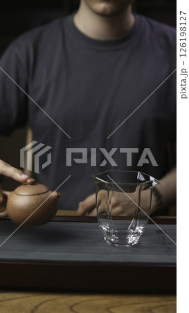 An Artisan Tea Setup with a Teapot and Glass Cup, enhancing the serene experience of brewing. Media 126198127