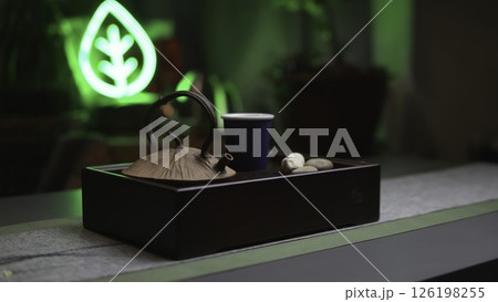 An Elegant Tea Setup Enhanced with Ambient Green Lighting for a Blissful Experience. Media 126198255