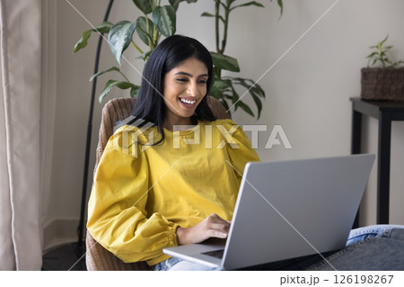 Happy young female enjoy home office comfort typing on notebook 126198267