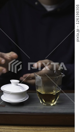 The Detailed Tea Brewing Process Using a Gaiwan and a Glass Cup for Enjoyment and Wellness. Media 126198308