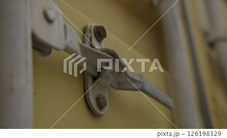 An Intricate Close Up View of a Metal Latch Affixed to a Bright Yellow Container. Stock Footage An Intricate Close Up View of a Metal Latch Affixed to a Bright Yellow Container. Stock Footage 126198329