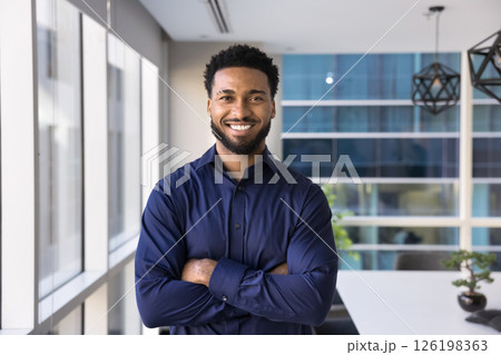 African businessman, trainer or CEO posing in contemporary conference room African businessman, trainer or CEO posing in contemporary conference room 126198363