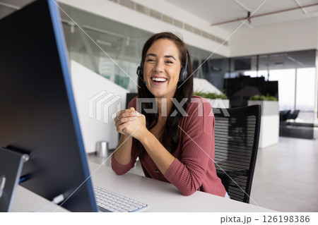Portrait happy motivated young woman telemarketer in earphones with mic Portrait happy motivated young woman telemarketer in earphones with mic 126198386