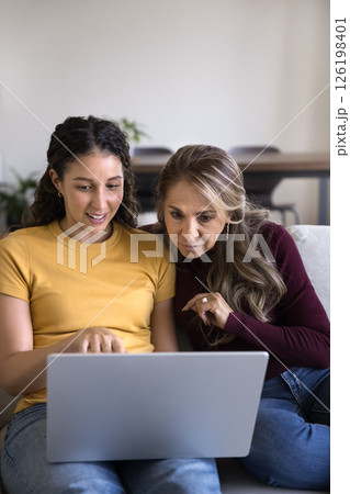 Caring grownup daughter zoomer teach aged mom to use notebook Caring grownup daughter zoomer teach aged mom to use notebook 126198401