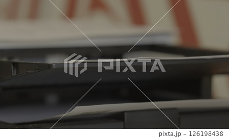 Documents Neatly Stacked on a Printer Shelf in an Organized Office Workspace Environment. Stock Footage 126198438