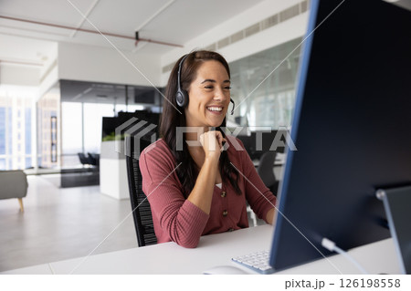 Young female remote working interpreter in headset talk via videocall 126198558