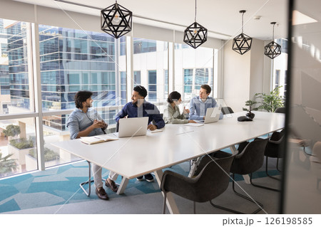 Diverse businesspeople lead formal talk seated at table in boardroom 126198585