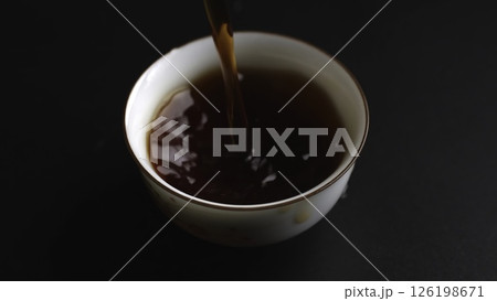 The process of pouring tea into a beautifully crafted traditional cup is quite an art. Media The process of pouring tea into a beautifully crafted traditional cup is quite an art. Media 126198671