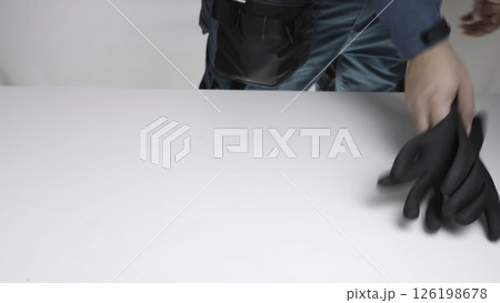 Video shows a person preparing a safe environment with PPE. Creative 126198678