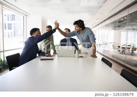 Happy multiethnic teammates celebrate joint success, shared goal achievement Happy multiethnic teammates celebrate joint success, shared goal achievement 126198679