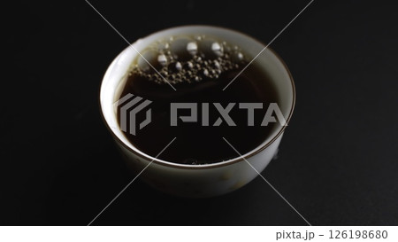 The process of pouring tea into a beautifully crafted traditional cup is quite an art. Media The process of pouring tea into a beautifully crafted traditional cup is quite an art. Media 126198680
